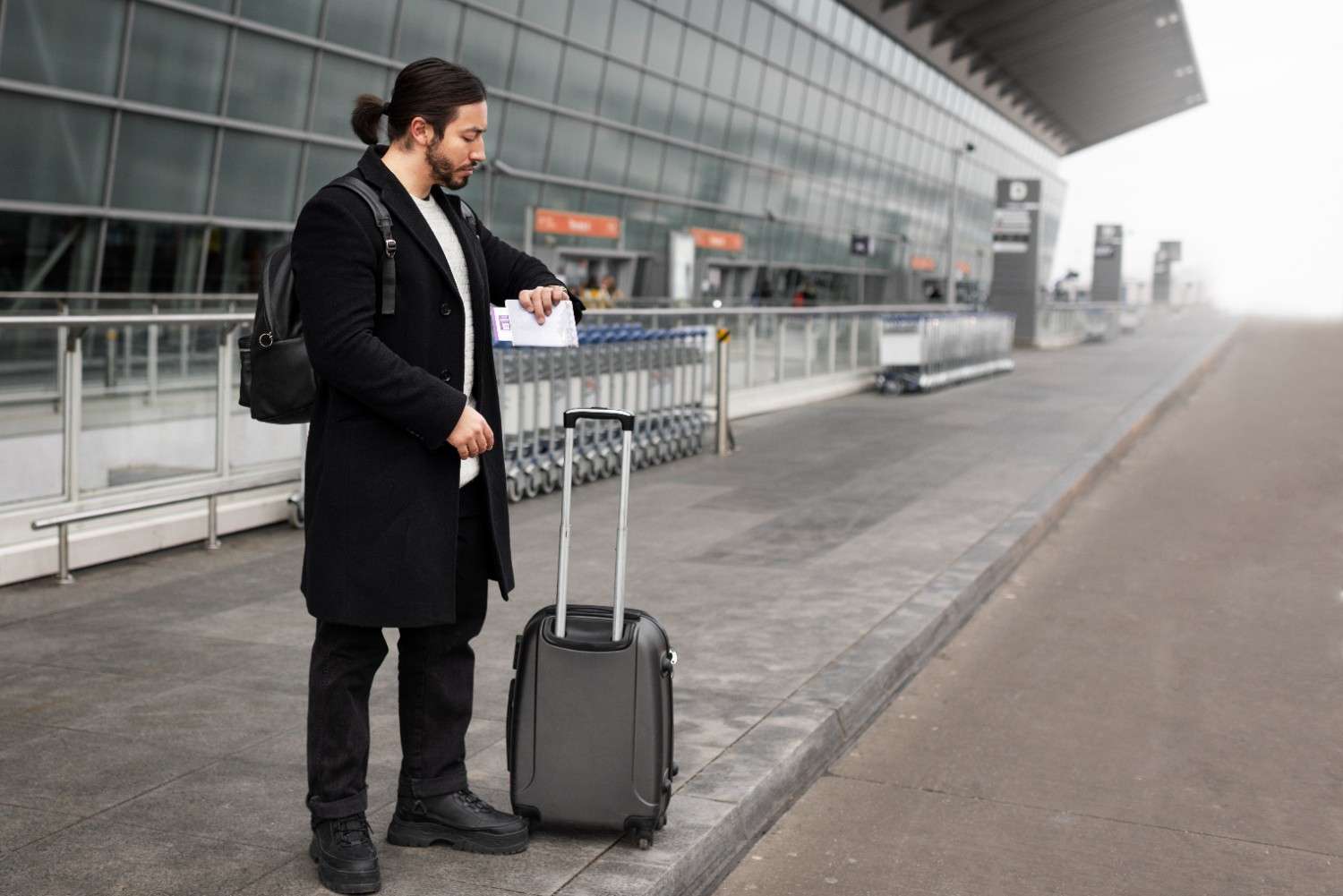 Man waiting outside the airport for a taxi