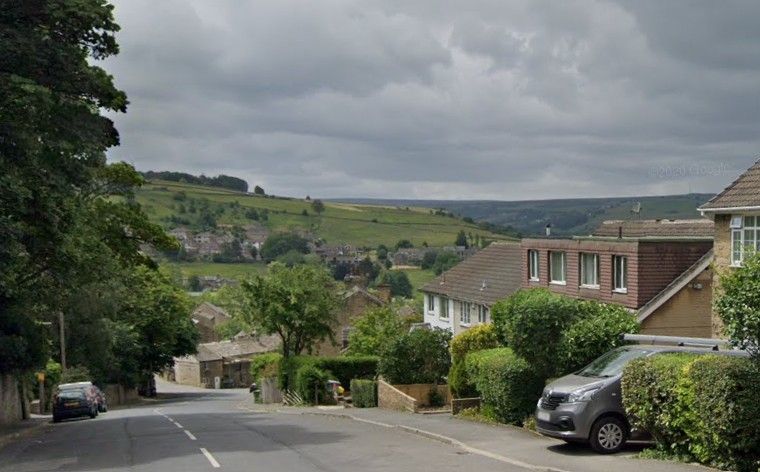 Street view of Linthwaite roads with scenic view of the countryside. Airport Taxi Huddersfield.